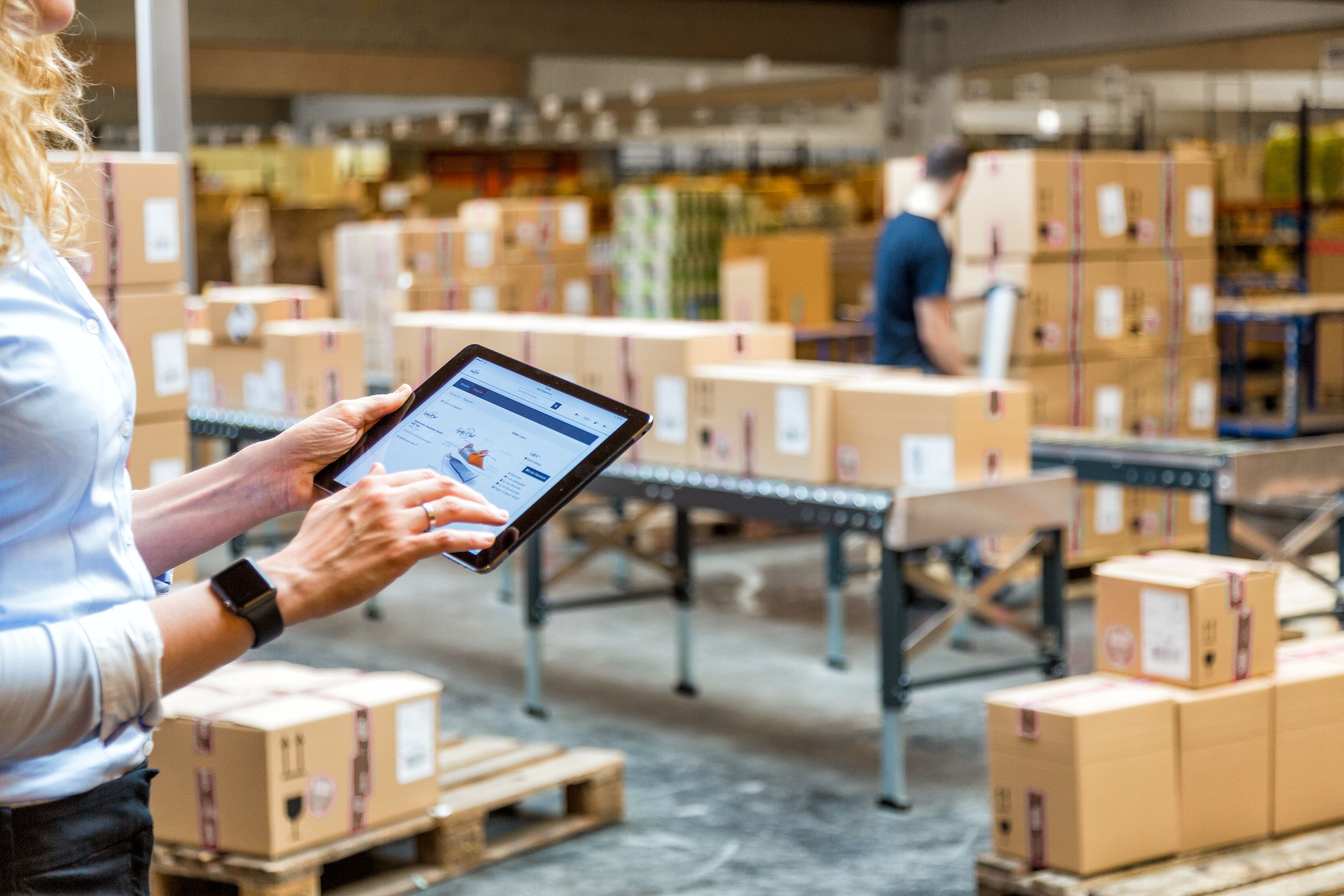E-Commerce_Female Warehouse Employee Using iPad