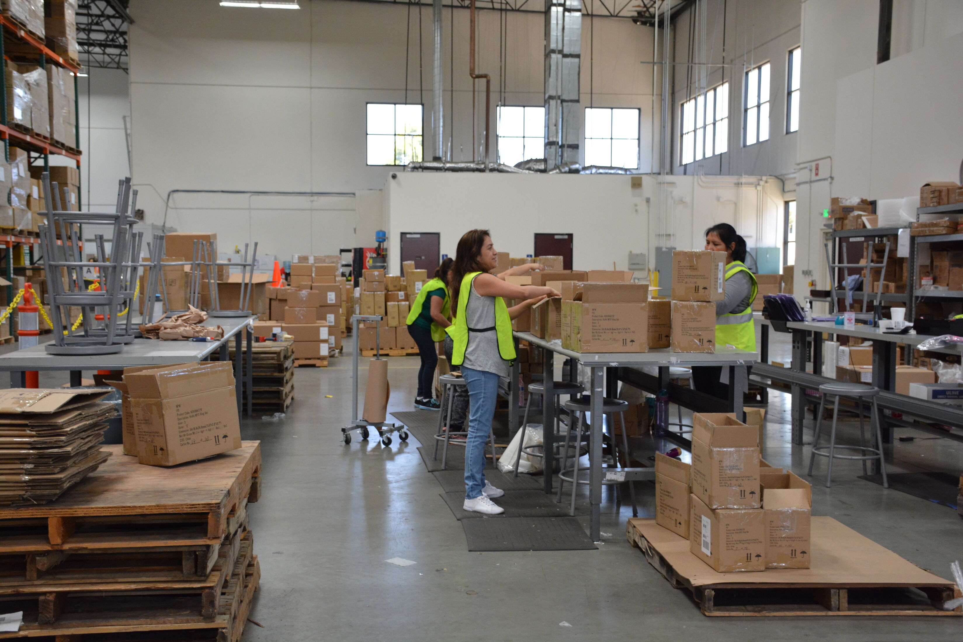 Warehouse employees conducting pick and pack and kitting fulfillment activities